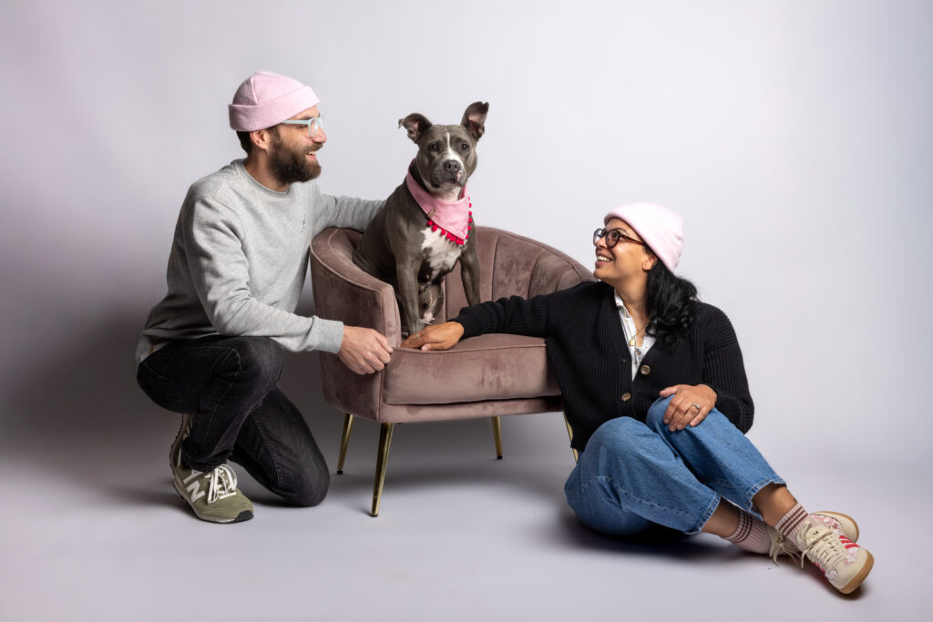 Two humans and their dog on a white background at Robyn White Photography Studio in Cleveland Ohio